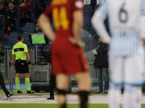 FILE -- In this Dec. 1st, 2017 file photo, referee Rosario Abisso, second from left, checks the Video Assistant Referee (VAR) during an Italian Serie A soccer match between AS Roma and Spal, at the Olympic stadium in Rome. The Italian referees association says it has been sent packages filled with bullets. The development comes amid fan protests over the video assistant referee (VAR), which is being introduced in Serie A this season to mixed results.
