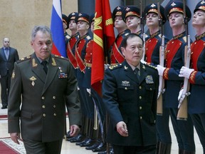 Russian Defense Minister Sergei Shoigu, left, and China's Defense Minister Wei Fenghe review an honour guard prior to their talks in Moscow, Russia, Tuesday, April 3, 2018. Wei emphasized that his visit to Russia is intended to underline close ties between the two nations and their intention to deepen strategic cooperation.