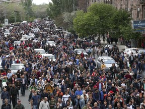 Demonstrators march in protest against the appointment of former President Serzh Sargsyan as the new prime minister, in Yerevan, Armenia, Sunday, April 22, 2018. The leader of major political protests that have gripped the Armenian capital for more than a week has been detained, and the streets of Yerevan are echoing with the blare of car horns in a new technique for expressing mass opposition.