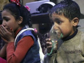 This image released early Sunday, April 8, 2018 by the Syrian Civil Defense White Helmets, shows a child receiving oxygen through respirators following an alleged poison gas attack in the rebel-held town of Douma, near Damascus, Syria. Syrian rescuers and medics said the attack on Douma killed at least 40 people. The Syrian government denied the allegations, which could not be independently verified. The alleged attack in Douma occurred Saturday night amid a resumed offensive by Syrian government forces after the collapse of a truce. (Syrian Civil Defense White Helmets via AP)