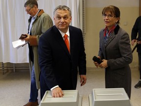 Hungary's prime minister Viktor Orban, left and his spouse Aniko Levai cast their ballots at a polling station in Budapest, Hungary, Sunday, April 8, 2018. Orban is expected to win his third consecutive term, and fourth overall since 1998, as voting stations opened across the country for the election of 199 parliamentary deputies.