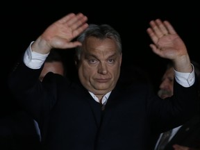 Hungarian Prime Minister Viktor Orban greets his supporters in Budapest, Hungary, Sunday, April 8, 2018. Preliminary results show populist Hungarian Prime Minister Viktor Orban has easily won a third consecutive term and his Fidesz party has regained its super majority in the parliamentary election.