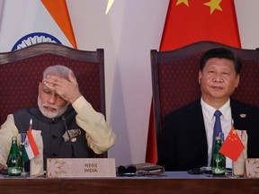 In this Oct. 16, 2016, file photo, Indian Prime Minister Narendra Modi, left, and Chinese President Xi Jinping attend the BRICS summit in Goa, India. Modi is travelling April 27-28, 2018 to meet with Xi for a visit that some experts have described as a possible way to reset a complicated relationship between the two Asian powers that has faced several tests last year, including a tense border standoff.