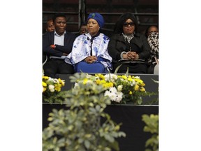 Daughters of anti-apartheid activist Winnie Madikizela-Mandela, Zenani and Zindzi Mandela, second and third from left, attend their mother's memorial service at Orlando, Stadium, in Soweto, South Africa, Wednesday, April 11, 2018. Madikizela-Mandela died on April 2 at the age of 81 after a long illness.