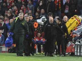 Liverpool's Alex Oxlade-Chamberlain is carried on a stretcher after getting injured during the Champions League semifinal, first leg, soccer match between Liverpool and AS Roma at Anfield Stadium, Liverpool, England, Tuesday, April 24, 2018.