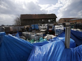 In this photo taken Monday, March 12, 2018, a view of old barrels and plastic containers full of liquid found at a farm in the northern town of Pancevo, Serbia. Discoveries such as these have triggered alarms in Serbia, where tons of poorly secured industrial waste are believed to be hidden. The issue has come into focus as Serbia and other Balkan nations move toward joining the European Union.
