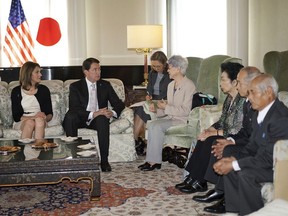 U.S. Ambassador to Japan William Hagerty, second from left, speaks to Sakie Yokota, fourth from right, and other members of the families of Japanese abducted to North Korea during a meeting at the ambassador's residence in Tokyo Tuesday, April 10, 2018. Families of Japanese abducted to North Korea decades ago asked Hagerty to urge U.S. President Donald Trump to discuss ways to win their loved ones' return home at his expected summit with the North's leader.