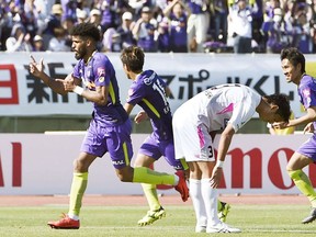 Brazilian striker Patric, left, of Sanfrecce Hiroshima celebrates after scoring a goal against Sagan Tosu during the J-League match in Hiroshima, western Japan Saturday April 21, 2018.