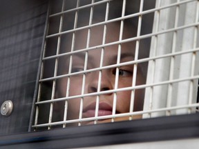 Anastasia Vashukevich sits inside a prison transport vehicle outside a courthouse in Pattaya, south of Bangkok, Thailand, Tuesday, April 17, 2018.  Russian sex guru and his followers, one of whom claims to have evidence of Moscow's interference in the 2016 U.S presidential election, have emerged briefly for a Thai court hearing after being held virtually incommunicado in an immigration jail. The group's leader, Alexander Kirillov, and the woman making the election claims, Vashukevich, were among about half a dozen people taken Tuesday to a court in the resort town of Pattaya, where they were arrested in February while holding a sex training course.