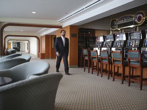 Hamza Mustafa, the CEO of Dubai's Ports, Customs and Free Zone Corp.'s investment arm, passes slot machines that will remain turned off as gambling is illegal, aboard the Queen Elizabeth 2, moored off the Mideast city-state of Dubai, United Arab Emirates, Tuesday, April 17, 2018. Britain's famed luxury cruise ship finally will have a soft opening Wednesday as a floating luxury hotel nearly a decade after arriving here following her last ocean voyage.