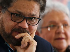 FILE - In this March, 8, 2018 file photo, Ivan Marquez, a former leader of the Revolutionary Armed Forces of Colombia, FARC, pauses during the announcement of the withdrawal of former guerrilla commander Rodrigo Londono from the race for president, citing both criticism of the political process and his serious health problems, at a press conference in Bogota, Colombia. The former chief peace negotiator for Colombia's FARC rebel movement said on Thursday, April 19, 2018, that he has decided to relocate to a rural camp for ex-guerrillas amid speculation he could soon be arrested as part of a U.S. drug investigation.