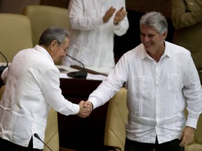 FILE - In this Dec. 20, 2014 file photo, Cuba's President Raul Castro, left, shakes hands with Vice President Miguel Diaz-Canel, at the closing of the legislative session at the National Assembly in Havana, Cuba. Cuban state media reported Monday, April 16, 2018, that the government has moved up the start of a session of the National Assembly in which Castro plans to step down and is expected to pass the presidency to the 57-year-old vice president. The session will now start Wednesday, April 17.