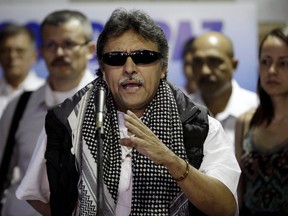 In this March 11, 2013 file photo, Jesus Santrich, a member of the negotiating team for Colombia's Revolutionary Armed Forces of Colombia (FARC), speaks to journalists at peace talks with Colombia's government in Havana, Cuba.