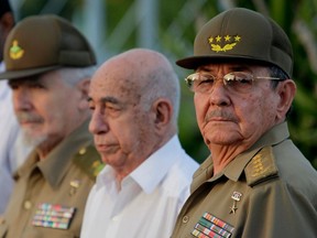 FILE - In this July 26, 2009 file photo, Cuba's authorities, from right, President Raul Castro, Vice-President Jose Ramon Machado Ventura and Revolutionary Commander Ramiro Valdes attend a rally marking Cuba's Day of National Rebellion in Holguin, Cuba. Castro, Machado and Valdez are some of the main government figures in the Cuban establishment preparing to usher in new leadership in 2018.
