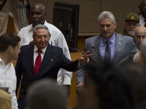 In this photo released by Cuba's state-run media Cubadebate, Cuba's President Raul Castro, center left, enters the National Assembly followed by his successor Miguel Diaz-Canel, center right, for the start of two-day legislative session in Havana, Cuba, Wednesday, April 18, 2018. The Cuban assembly selected the 57-year-old First Vice President as the sole candidate to succeed Castro on Wednesday, in a transition aimed at ensuring that the country's single-party system outlasts the aging revolutionaries who created it.