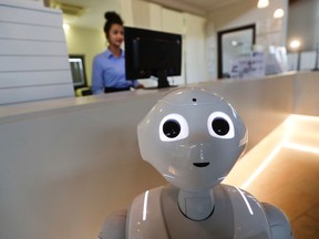 In this photo dated March 12, 2018, robot Robby Pepper stands at the front desk of hotel in Peschiera del Garda, northern Italy, Monday, March 12, 2018. Robby Pepper, billed as Italy's first robot concierge, has been programed to answer simple guest questions in Italian, English and German, the humanoid, speaking robot will be deployed all season at a hotel on the popular Garda Lake to help relieve the desk staff of simple, repetitive questions.