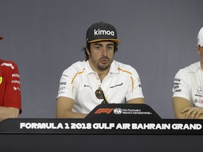 From left, Ferrari driver Kimi Raikkonen of Finland, is flanked by McLaren driver Fernando Alonso of Spain and Mercedes driver Valtteri Bottas of Finland answer reporter questions during a press conference, at the Formula One Bahrain International Circuit in Sakhir, Bahrain, Thursday, April 5, 2018. The Bahrain Formula One Grand Prix will take place here on Sunday.