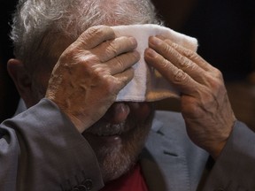 Brazil's former President Luiz Inacio Lula da Silva wipes sweat from his face during his presidential campaign rally with members of his Workers Party and leaders of other left-wing parties in Rio de Janeiro, Brazil, Monday, April 2, 2018. Despite a conviction on corruption charges that could see him barred from running, da Silva is the front runner in that race.