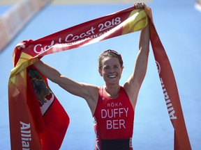 Flora Duffy of Bermuda celebrates as she wins the women's triathlon at Southport Broadwater Parklands in the 2018 Commonwealth Games on the Gold Coast, Australia, Thursday, April 5, 2018.