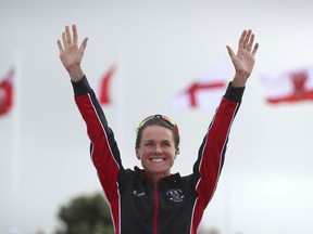Flora Duffy of Bermuda celebrates during the medal ceremony in the women's triathlon at Southport Broadwater Parklands in the 2018 Commonwealth Games on the Gold Coast, Australia, Thursday, April 5, 2018.