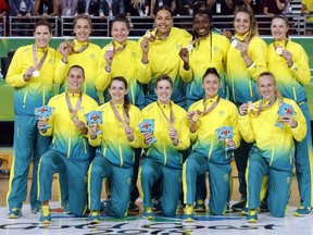 Members of Australia's women's basketball team stand with their gold medals at the Gold Coast Convention and Exhibition Centre during the 2018 Commonwealth Games on the Gold Coast, Australia, Saturday, April 14, 2018.