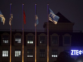 In this March 16, 2016, photo, flags fly over the ZTE Global Cloud Computing Center in Nanjing in eastern China's Jiangsu province. Chinese tech company ZTE said Friday, April 20, 2018, that it won't accept an "unfair" U.S. penalty in a case involving exports of telecoms equipment to North Korea and Iran and is seeking a solution through legal channels. (Chinatopix via AP)