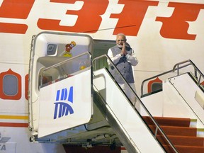 India's Prime Minister Narendra Modi gestures as he arrives at the airport in Wuhan, central China's Hubei Province, early Friday April 27, 2018. Modi is in China for what Chinese state media has described as a two-day "informal meeting" with Chinese President Xi Jinping. (Chinatopix via AP)