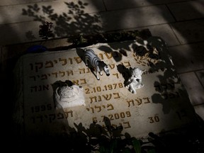 Small items placed on the gravestone of Israeli police officer Anton Solimiko at Kiryat Shaul military cemetery on the eve of memorial Day in Tel Aviv, Israel, Tuesday, April 17, 2018. Israel marks the annual Memorial Day in remembrance of soldiers who died in the nation's conflicts, beginning at dusk Tuesday until Wednesday evening.