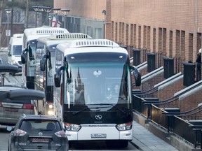 Buses believed to be carrying expelled diplomats prepare to leave the U.S. Embassy in Moscow, Russia, Thursday, April 5, 2018. Russia last week ordered 60 American diplomats to leave the country by Thursday, in retaliation for the United States expelling the same number of Russians.