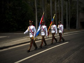 The Cuban honor guard carry Cuban and Venezuelan flags after a ceremony at the Jose Marti Monument with Venezuela's President Nicolas Maduro, in Havana, Cuba, Saturday, April 21, 2018. Maduro is in Cuba for a two-day visit.