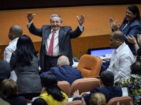 Outgoing President Raul Castro raises his arms in celebration after Miguel Diaz-Canel was elected as the island nation's new president, at the National Assembly in Havana, Cuba, Thursday, April 19, 2018.  Castro passed Cuba's presidency to Diaz-Canel, putting the island's government in the hands of someone outside the Castro family for the first time in nearly six decades. He remains head of the powerful Communist Party that oversees political and social activities.