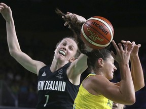 Australia's Alice Kunek, right, has the ball knocked away by New Zealand's Antonia Edmondson during their women's semifinal basketball game at the Convention Centre during the 2018 Commonwealth Games on the Gold Coast, Australia, Friday, April 13, 2018.