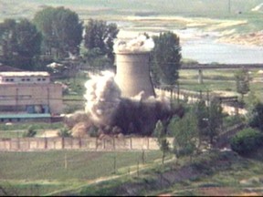 FILE- In this June 27, 2008 file image from television, the demolition of the 60-foot-tall cooling tower at its main reactor complex in Yongbyon North Korea. When North Korean leader Kim Jong Un meets South Korean President Moon Jae-in on Friday, April 27, 2018, the world will have a single overriding interest: How will they address North Korea's decades-long pursuit of nuclear-armed missiles? (AP Photo/APTN, File)