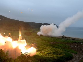 FILE - In this July 29, 2017 file photo provided by South Korea Defense Ministry, South Korea's Hyunmoo II Missile system, left, and a U.S. Army Tactical Missile System, right, fire missiles during a combined military exercise between the two countries against North Korea at an undisclosed location in South Korea. The United States and South Korea have toned down their annual war games as North Korean leader Kim Jong Un prepares for summits with South Korea and President Donald Trump. The annual maneuvers have been the center of contention for decades, but with diplomacy now in the air they might turn out to be a powerful bargaining chip. (South Korea Defense Ministry via AP, File)