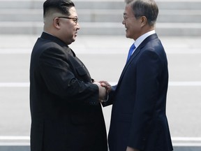 North Korean leader Kim Jong Un, left, shakes hands with South Korean President Moon Jae-in at the border village of Panmunjom in the Demilitarized Zone Friday, April 27, 2018. Kim made history Friday by crossing over the world's most heavily armed border to greet his rival, Moon, for talks on North Korea's nuclear weapons. (Korea Summit Press Pool via AP)