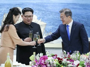 South Korean President Moon Jae-in, right, toasts with Ri Sol Ju, wife of North Korean leader Kim Jong Un during a banquet at the border village of Panmunjom in the Demilitarized Zone, South Korea, Friday, April 27, 2018. (Korea Summit Press Pool via AP)