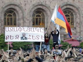 Protesters react while listening to their leader Nikol Pashinian during a rally in Yerevan, Armenia, Sunday, April 29, 2018. The leader of the wave of protests that has pushed Armenia into a political crisis says he has met with the country's president. Pashinian said Sunday that he hopes President Armen Sarkisian will support Pashinian's bid to become prime minister. The parliament is to choose a new premier on Tuesday, following the resignation last week of Serzh Sargsyan.