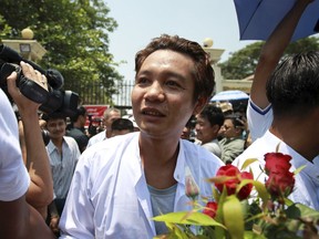 A prisoner walks outside the gate of Insein prison as he was released, Tuesday, April. 17, 2018, Yangon, Myanmar. Myanmar President Win Myint has granted amnesty to more than 8,500 prisoners, reportedly including at least three dozen political prisoners.