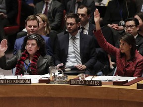 Karen Pierce, left, British Ambassador to the United Nations, and Nikki Haley, United States Ambassador to the United Nations, vote in favor of a resolution for an independent investigation on the use of chemical weapons in Syria, Tuesday, April 10, 2018, at United Nations headquarters.