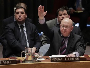 After vetoing the first draft resolution presented by the United States, Russian Ambassador to the United Nations Vasily Nebenzya votes in favor a second draft resolution presented by Russia for an independent investigation of the use of chemical weapons in Syria during a Security Council meeting, Tuesday, April 10, 2018, at U.N. headquarters.
