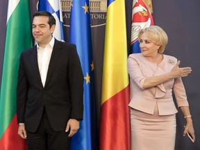 Greek Prime Minister Alexis Tsipras, left, smile after shaking hands with Romanian counterpart Viorica Dancila, at the Victoria Palace, the Romanian government headquarters in Bucharest, Romania, Tuesday, April 24, 2018. Prime ministers from Greece, Bulgaria, Romania and the President of Serbia attend a meeting focused on regional cooperation and Serbia's European integration.