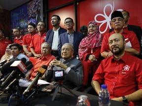 Former Malaysian Prime Minister and Malaysia's opposition United Indigenous Party (PPBM) chairman Mahathir Mohamad, center, speaks during a press conference in Petaling Jaya, Malaysia, Thursday, April 5, 2018. Malaysian authorities ordered former Prime Minister Mahathir Mohamad's political party to temporarily disband Thursday in a blow to the opposition ahead of expected general elections.