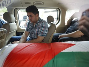 The coffin of Palestinian Fadi al-Batsh is seen in a hearse out of a hospital's morgue in Selayang, on the outskirt of Kuala Lumpur, Malaysia, Wednesday, April 25, 2018. The Palestinian envoy in Malaysia says the body of the Hamas militant killed last week in Kuala Lumpur will be repatriated to the Gaza Strip for burial. Fadi al-Batsh, an electrical engineering lecturer at a Malaysian university, was gunned down by two men on a motorcycle as he was on his way to a mosque early Saturday.