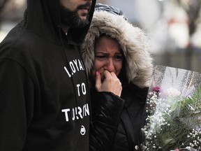 A woman cries at a vigil on Toronto's Yonge Street honouring the victims of the van attack that killed 10 and injured 14, on Tuesday, April 24, 2018.