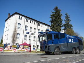 A water canon stands in front of the hotel Neisseblick in  Ostritz, Germany Friday, April 20, 2018. A court has banned the consumption of alcohol at a planned neo-Nazi concert in eastern Germany to prevent an outbreak of violence. The weekend festival in the town of Ostritz is expected to attract up to 1,000 far-right extremists from Germany, the neighboring Czech Republic and Poland.