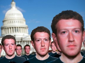 One hundred cardboard cutouts of Facebook CEO Mark Zuckerberg stand outside the U.S. Capitol in Washington on April 10, 2018. Advocacy group Avaaz is calling attention to what the group says are hundreds of millions of fake accounts still spreading disinformation on Facebook.