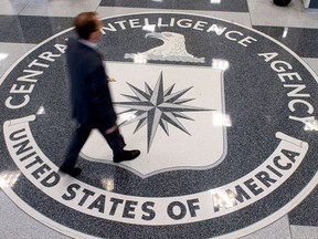 This August 14,2008 file photo shows a man as he crosses the Central Intelligence Agency (CIA) logo in the lobby of CIA Headquarters in Langley, Virginia.