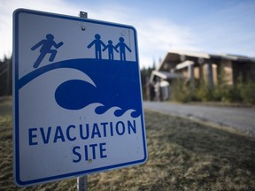 A tsunami evacuation site sign is shown on high ground near the House of Huuayaht in the village of Anacla in Pachena Bay, B.C. Wednesday, Jan. 14, 2015.