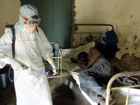 This file photo taken on March 9, 2003 shows an agent of the Congolese Red Cross disinfecting a room of the Kelle hospital, northwestern Congo, where an Ebola fever infected patient lies.