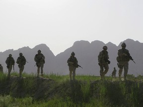 Canadian soldiers patrol an area in the Dand district of southern Afghanistan on Sunday, June 7, 2009.